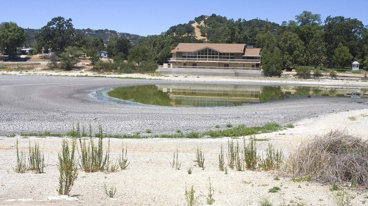 The Pavillion at the Lake is reflected in the water that remained in Atascadero Lake on Friday, June 27.