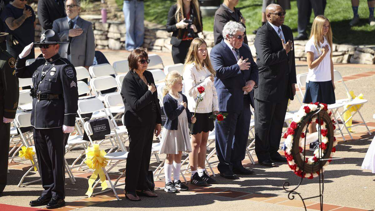 Dr. James Johnson-Hill, chaplain with San Luis Obispo Police Department, right, stands with the family of Det. Luca Benedetti who died in the line of duty five years ago. The county’s annual Peace Officers’ Memorial ceremony was held at Mission Plaza on May 7, 2026.