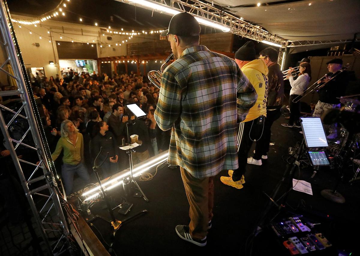 A big crowd dances in front of the band. Brass Mash is a local all-brass instrument mash-up band. They’re an eclectic group of musicians ranging in age from 21 to 70.
