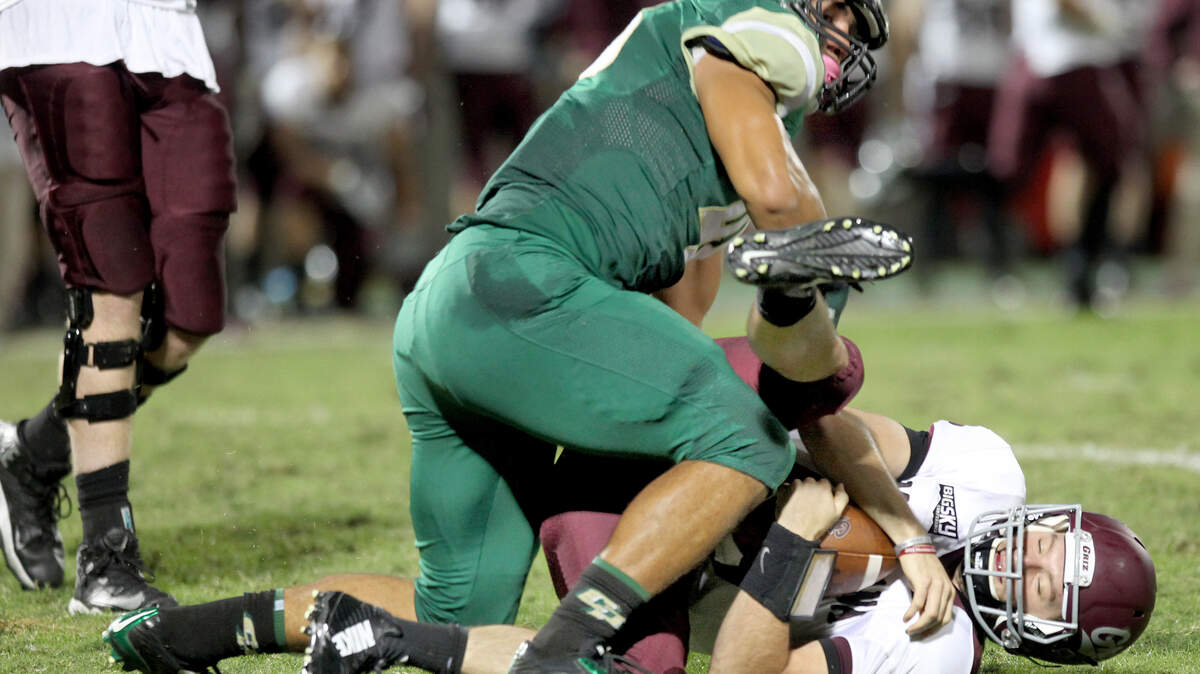 Cal Poly plays Montana at Alex G. Spanos Stadium, Saturday, October 25, 2014. Cal Poly's Josh Letuligasenoa (48) sacks Montana's quarterback Jordan Johnson (10) during first half play.