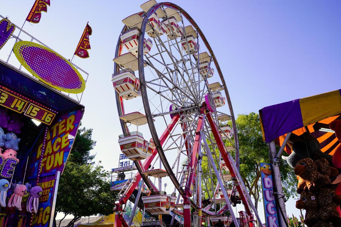 The Century Wheel ride stands above boardwalk games at the California Mid-State Fair on Wednesday, July 16, 2025. 