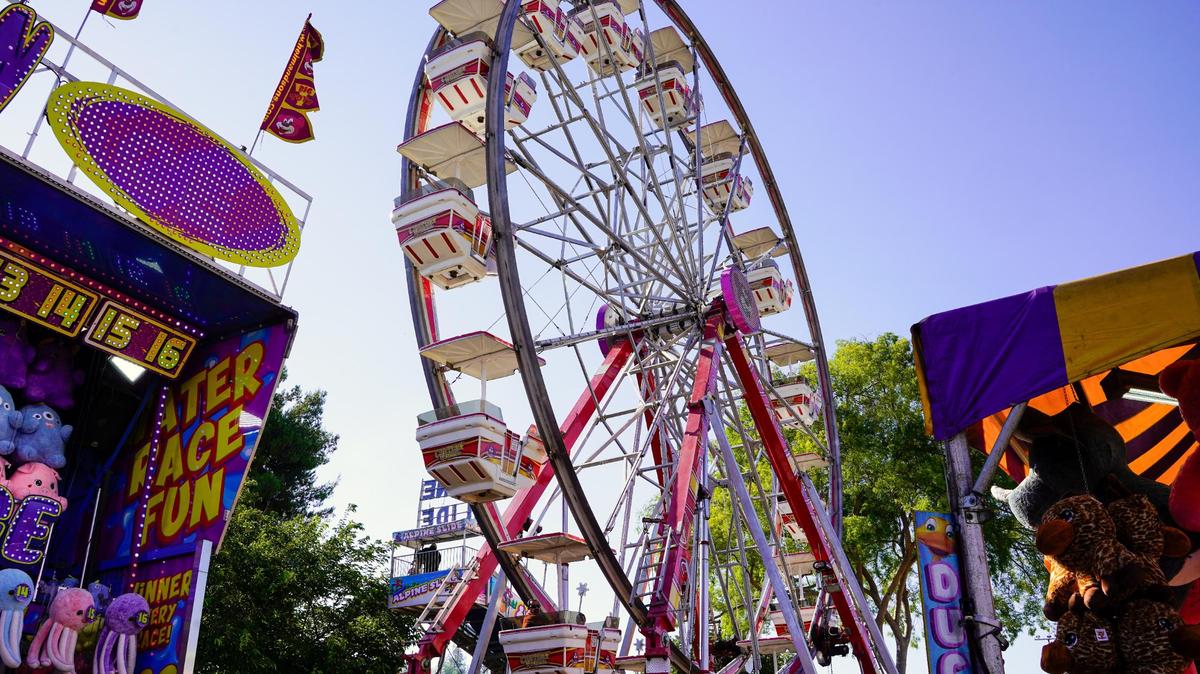 The Century Wheel ride stands above boardwalk games at the California Mid-State Fair on Wednesday, July 16, 2025. The Mid-State Fair will run from July 16-27.