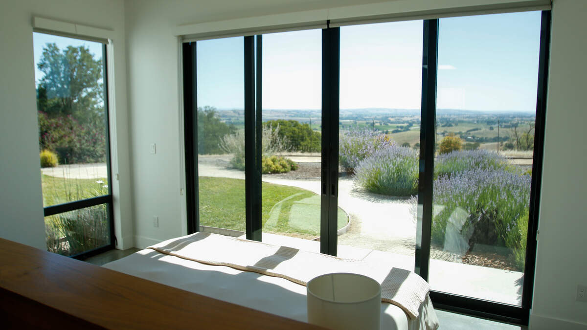 The bedroom of a 705 Sequoia Lane looks out over rolling hills east of Atascadero on Wednesday, June 10, 2026. The 12-acre estate features the first commercial planting of Nero di Troia grapevines — native to Italy’s Puglia region — in the United States.