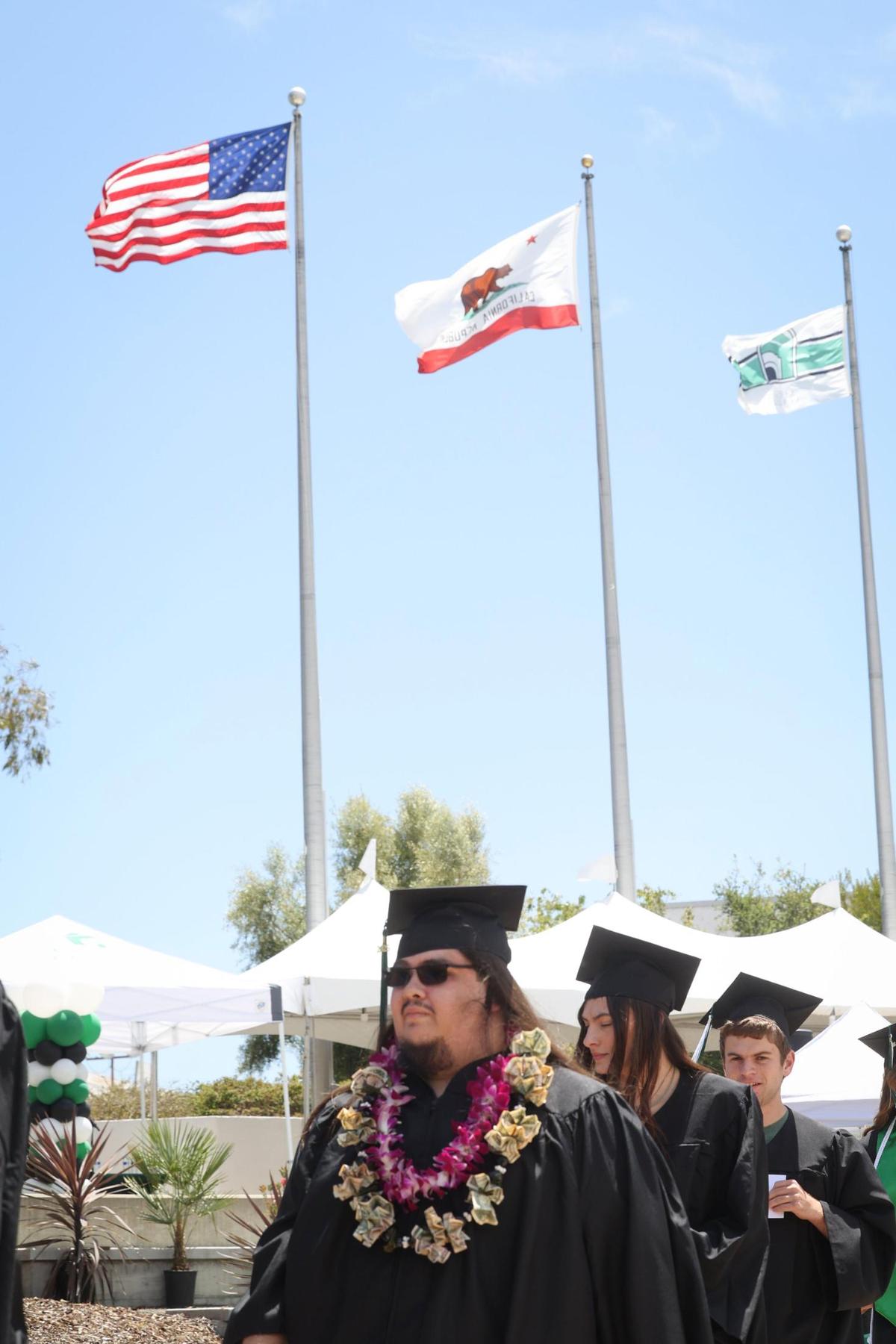 Wind was snapping the flags as graduates walked to their place at the outdoor ceremony. Cuesta College celebrated its 60th Commencement Ceremony on campus May 23, 2025.