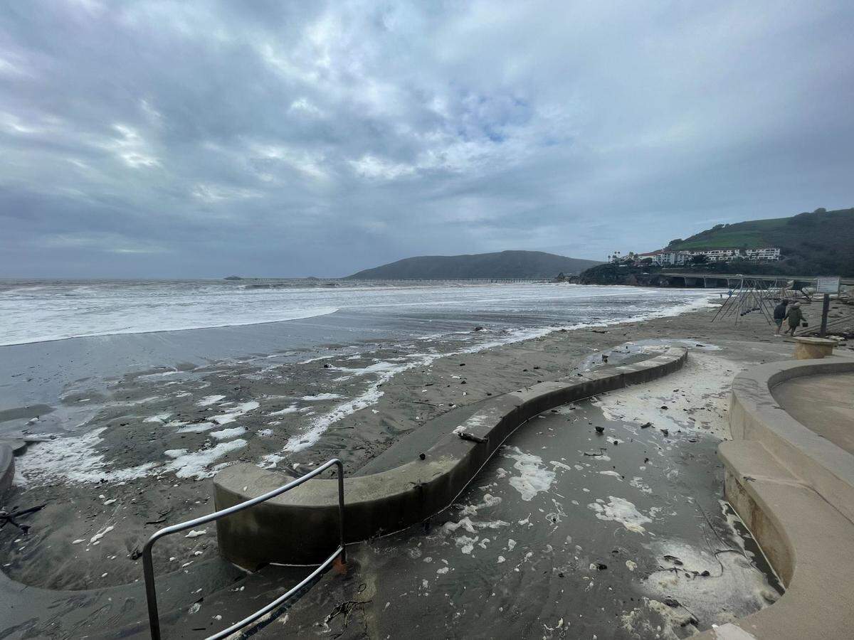 Swaths of marshmallow-like seafoam cover a walkway leading to the sand in Avila Beach on Thursday, Jan. 5, 2023, following a powerful winter storm.
