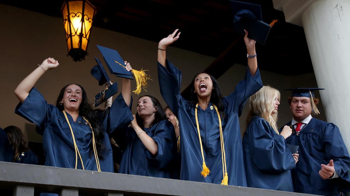 Mya Gonzales, right, spies her family in the crowd after the Mission Prep graduation ceremony. Eighty-three Mission Prep students graduated in San Luis Obispo, earning nearly $2 million in scholarships.