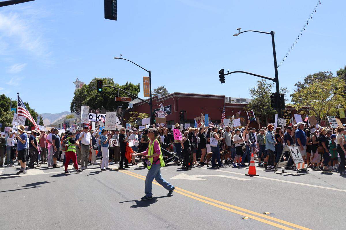 Thousands gathered in San Luis Obispo, California, for No Kings Day to protest executive overreach by the Trump administration on the President’s birthday. Traffic control volunteers corralled protestors off the street and onto the sidewalks.