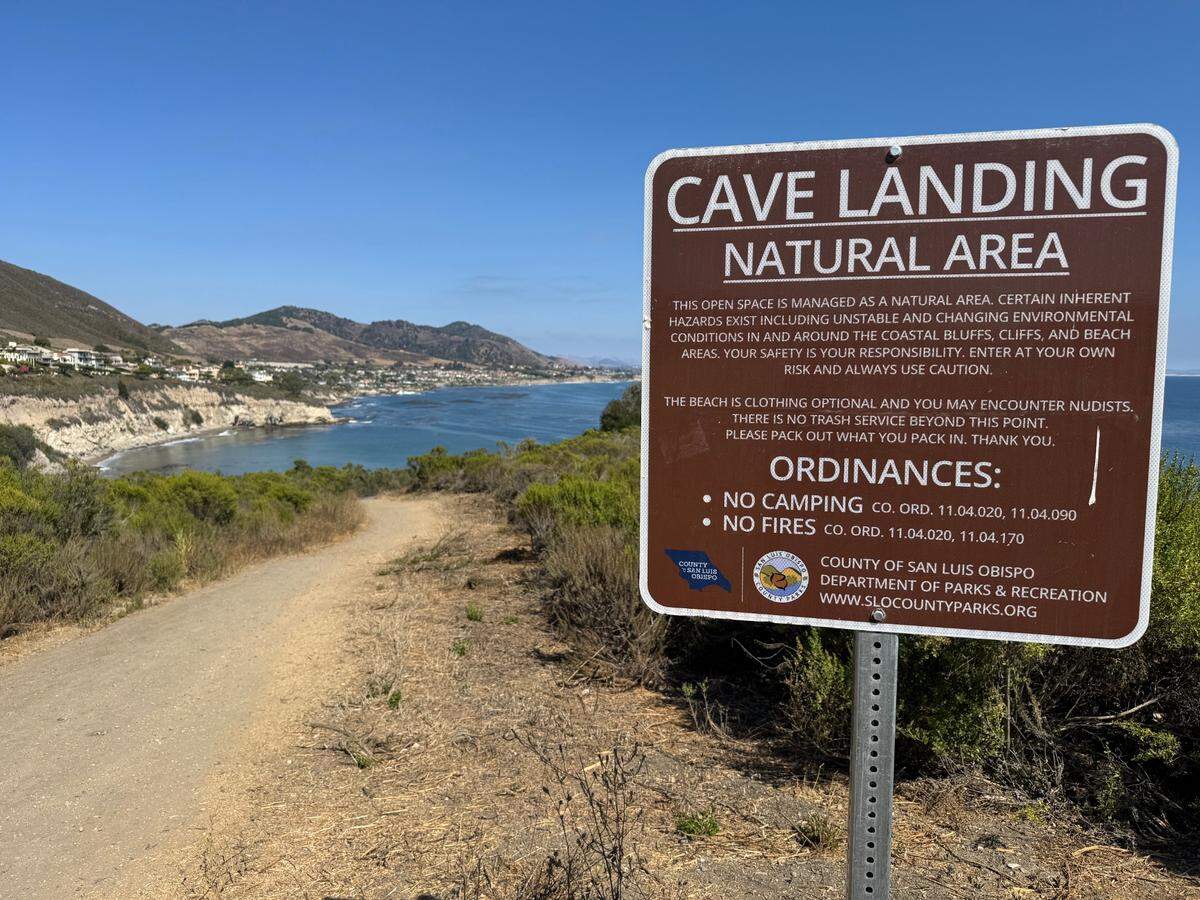 A sign with visitor information for Cave Landing near Pirate’s Cove in Avila Beach.