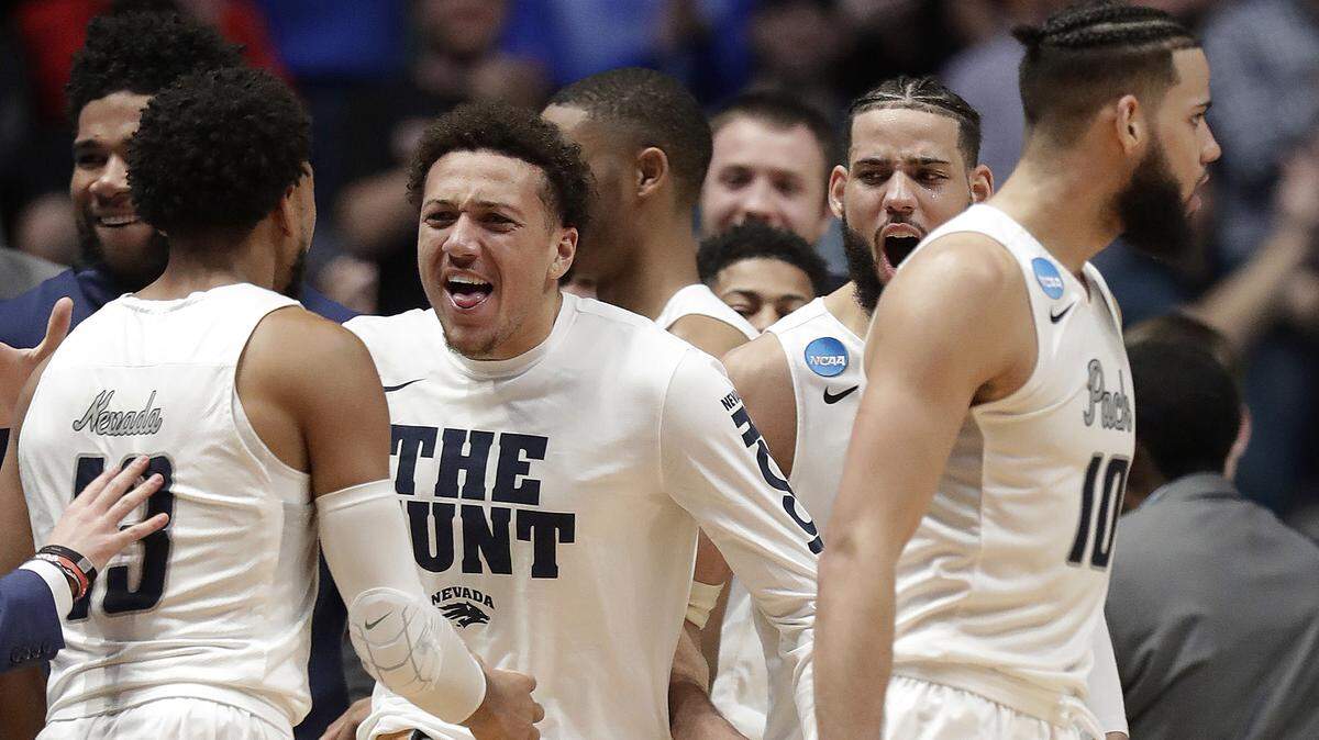 Atascadero High graduate Elijah Cooks (left) and the Nevada bench reacts after beating Texas in overtime of a first-round game of the NCAA college basketball tournament in Nashville, Tenn., Friday, March 16, 2018. Nevada won 87-83.