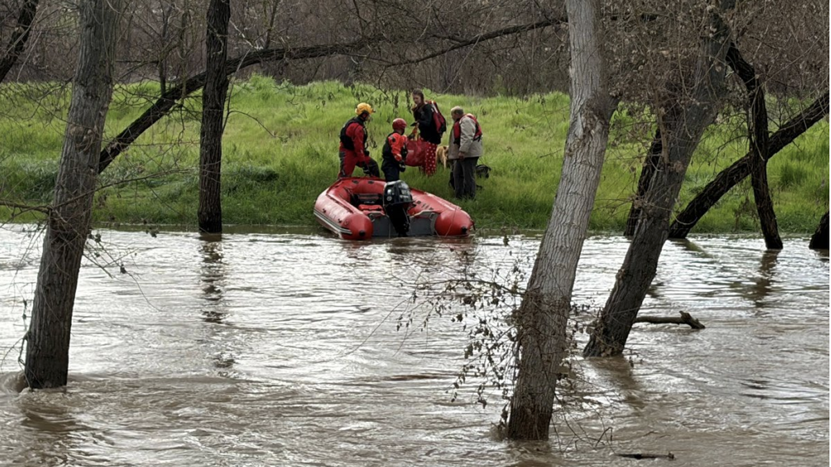 Emergency responders rescued two people and five dogs from an island in the rain-swollen Salinas River on Wednesday, Feb. 18, 2026.