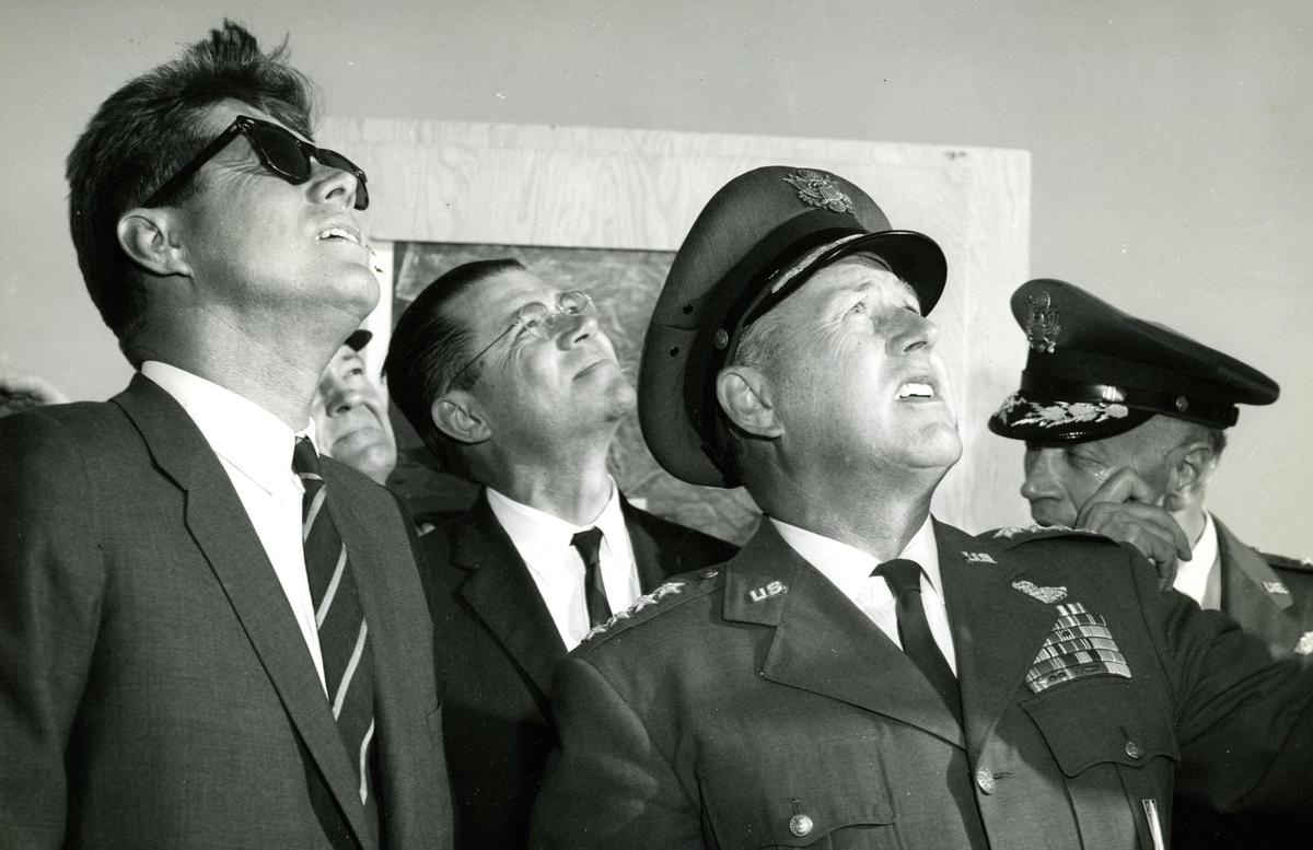 From the left President John F. Kennedy, secretary of defense Robert McNamara and General Thomas Powers watch an Atlas rocket takes flight from Vandenberg Air Force Base March 23, 1962.