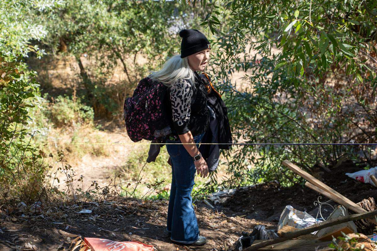 Grassroots homeless advocate Kimberlee Booth speaks to a homeless woman in the Salinas Riverbed on Thursday, Oct. 16, 2025.