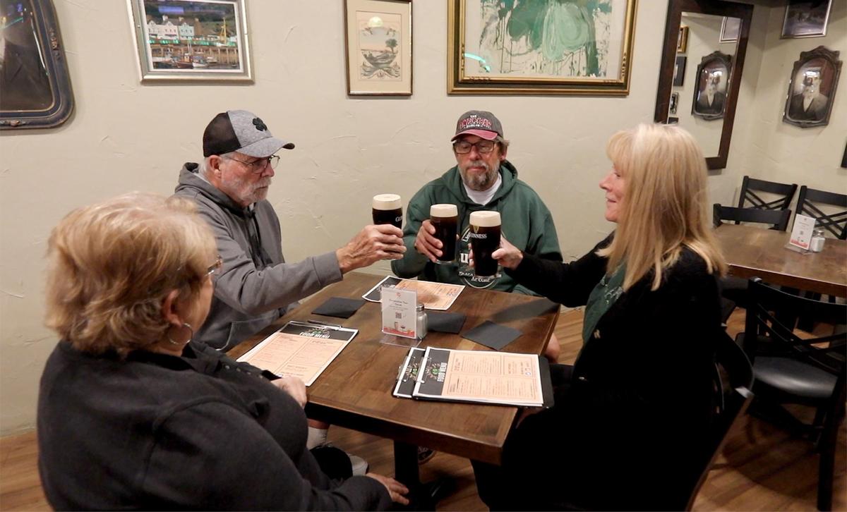 From left, Becky and Gary Holleran, Bob and Kelly Davis, of Morro Bay, do a toast with Guinness beer in Sammy J’s restaurant in Morro Bay.