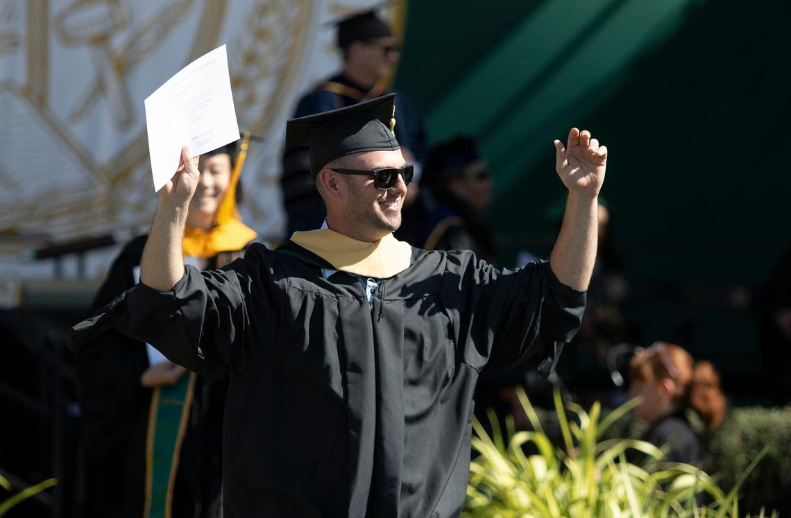 Cal Poly kicked off graduation weekend with three ceremonies on June 15, 2024. The university expects to celebrate more than 6,300 graduates throughout the weekend. Trevor Autry raises his arms after he receives his diploma.