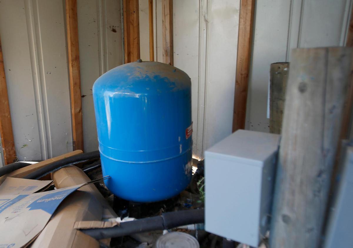 One of Lloyd “Ed” Rickard’s wellheads is inside a shed on his property in rural Paso Robles. After Rickard’s well went dry in 2018, he trucked in water for several years before saving up $30,000 to drill a deeper well.