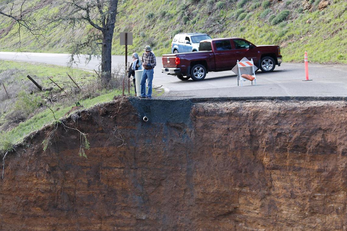 Residents stranded after Chimney Rock Road northwest of Paso Robles washed out during a recent rain storm check out the damage on Saturday, March 11, 2023. 