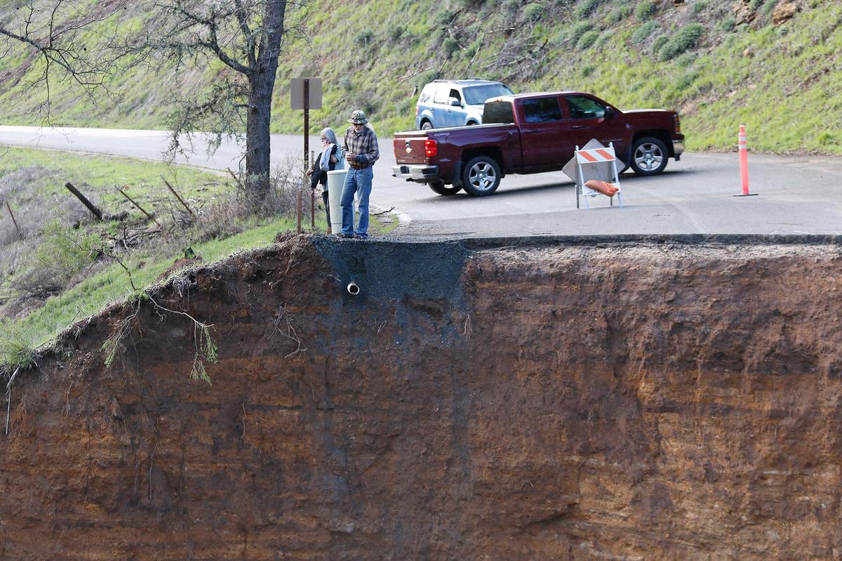 Residents stranded after Chimney Rock Road northwest of Paso Robles washed out during a recent rain storm check out the damage on Saturday, March 11, 2023.