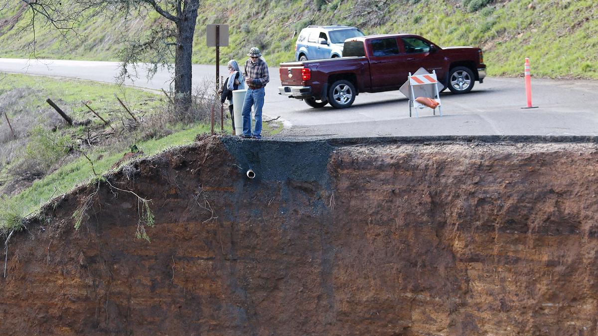 Residents stranded after Chimney Rock Road northwest of Paso Robles washed out during a recent rain storm check out the damage on Saturday, March 11, 2023.
