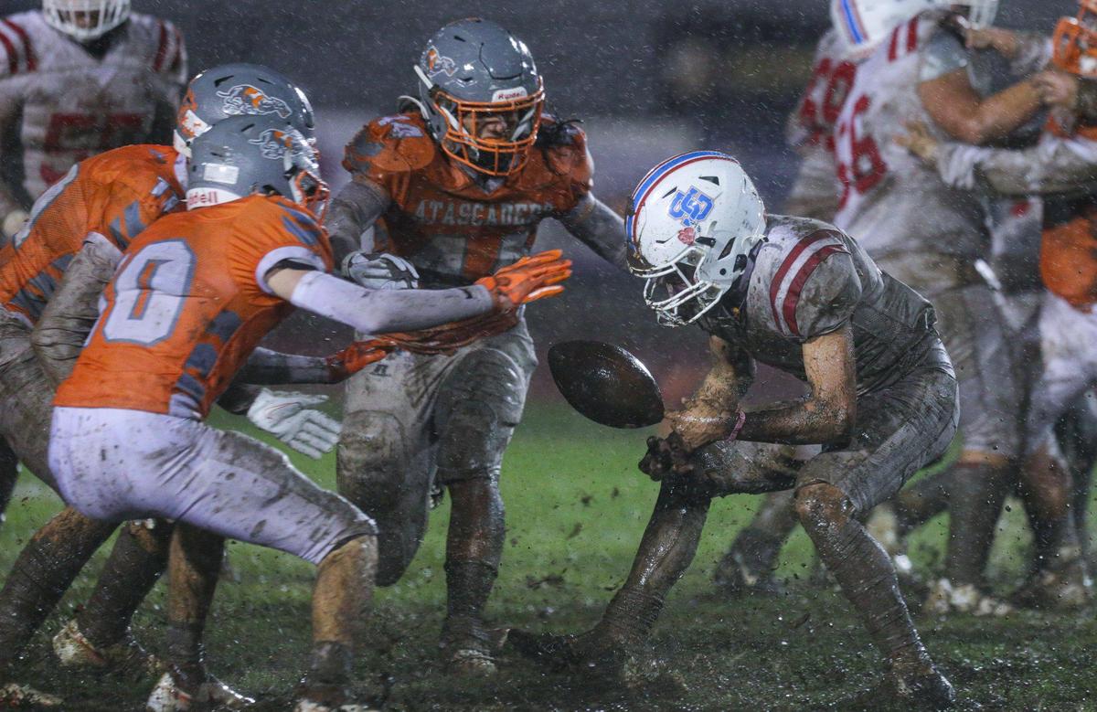 The ball gets away from Matador running back Robert Lucero as a group of Atascadero players close in. Slick conditions led to no passing and several turnovers. The Atascadero Greyhounds beat the San Gabriel Matadors 41-0 to win the CIF Division 6-A State Championship football game on Dec. 10, 2022.
