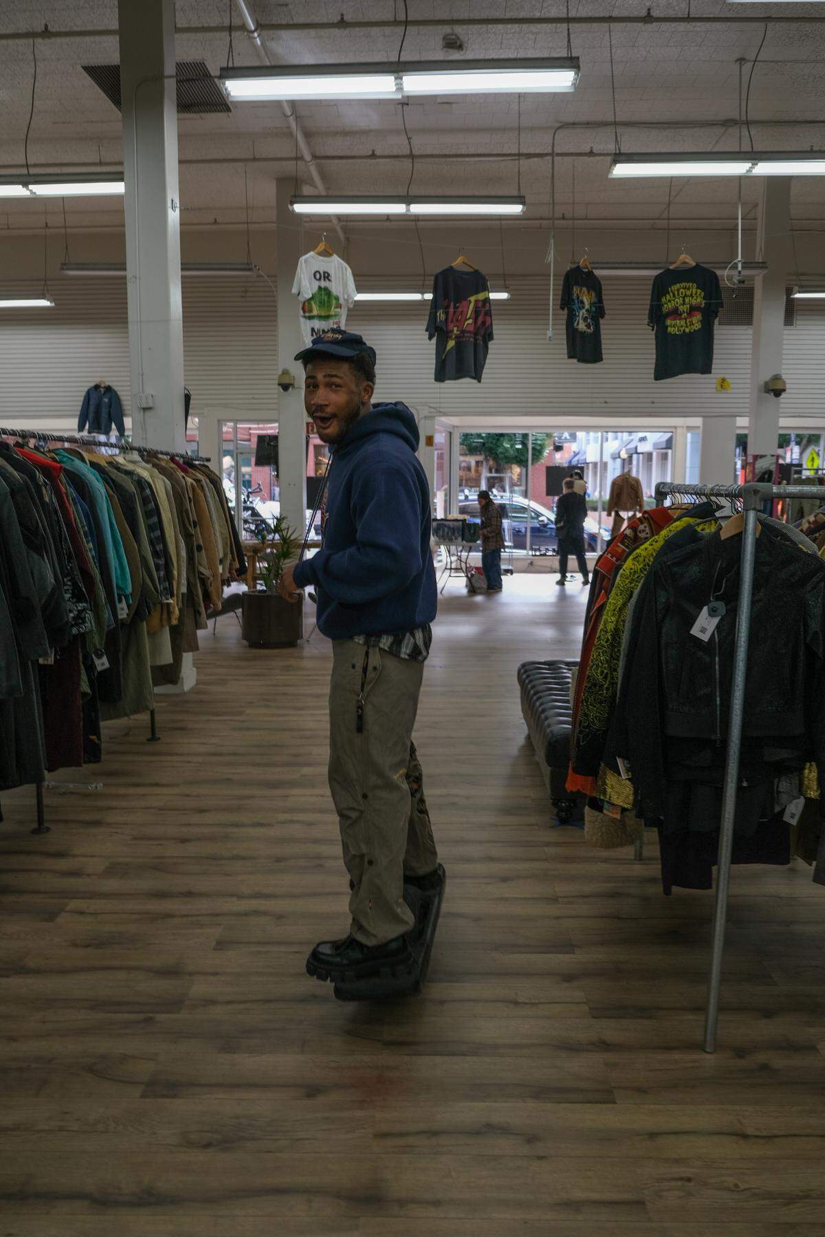 Adam Kemp, co-owner of Thrifty Beaches, hoverboards as he helps shoppers on Black Friday in his downtown San Luis Obispo store on Nov. 29, 2024.
