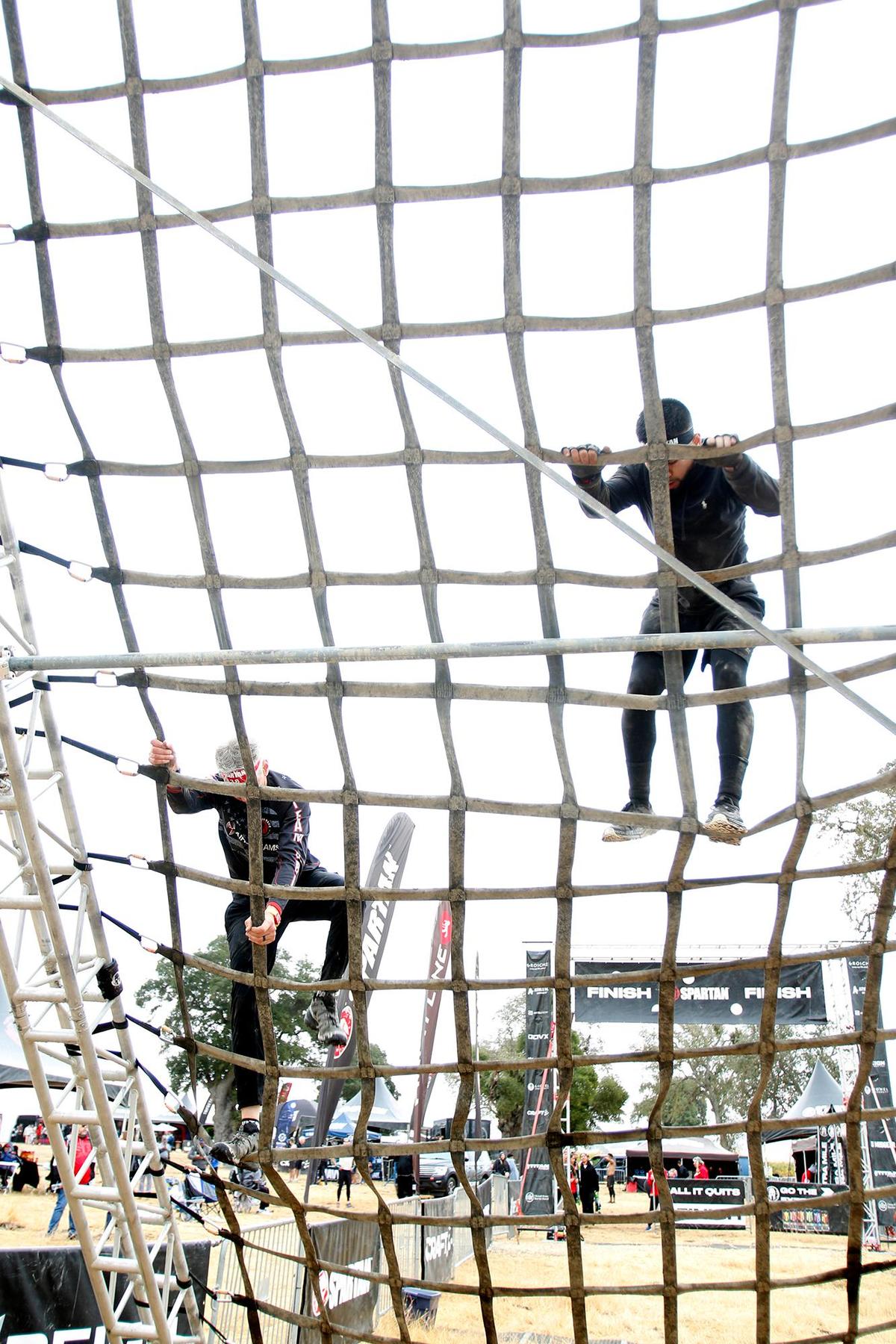 Race participant climb the A-frame at the Spartan race event held in Santa Margarita on Saturday, Nov. 2, 2024, featuring a variety of obstacles and courses of different challenge levels.