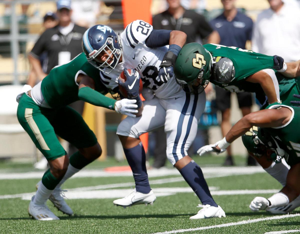 Cal Poly defensive tackle team takes down San DiegoÕs Chris Childrers (28) in first half play. Cal Poly Mustangs beat San Diego ToreroÕs 28 - 27 at Alex G. Spanos stadium San Luis Obispo, Saturday, Sept 10, 2022.