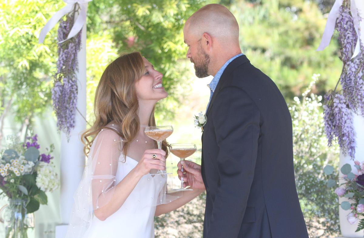 Berenice Saint-Saens and Ryan Buckley were married in the backyard of their Arroyo Grande home and invited friends and family to join via Zoom. Here they share a toast. David Middlecamp 4-2-2020