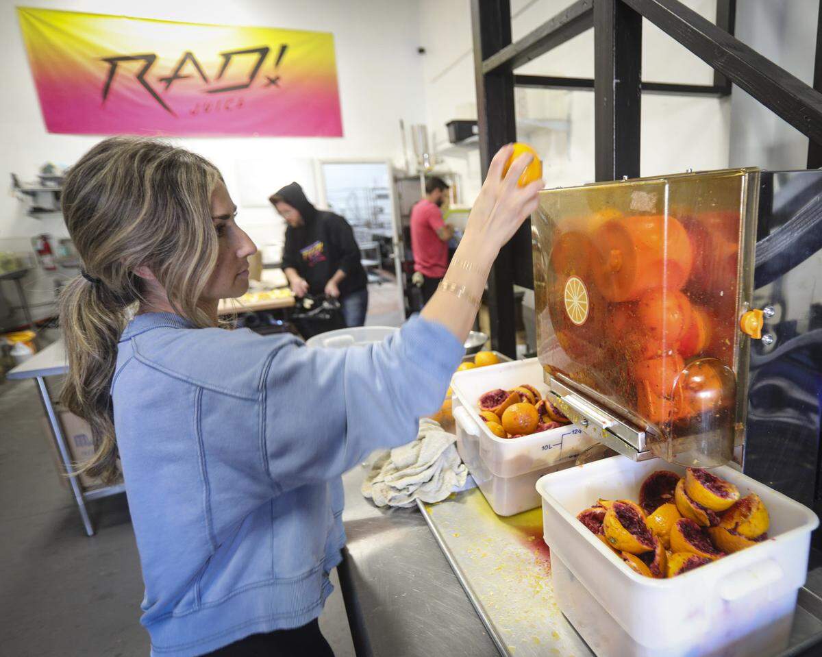 Lindsay Plough squeezes blood oranges. RAD juice offers cold-pressed organic juices, fresh and available for delivery or at local Farmer's Markets, seen here on Jan. 22, 2026.