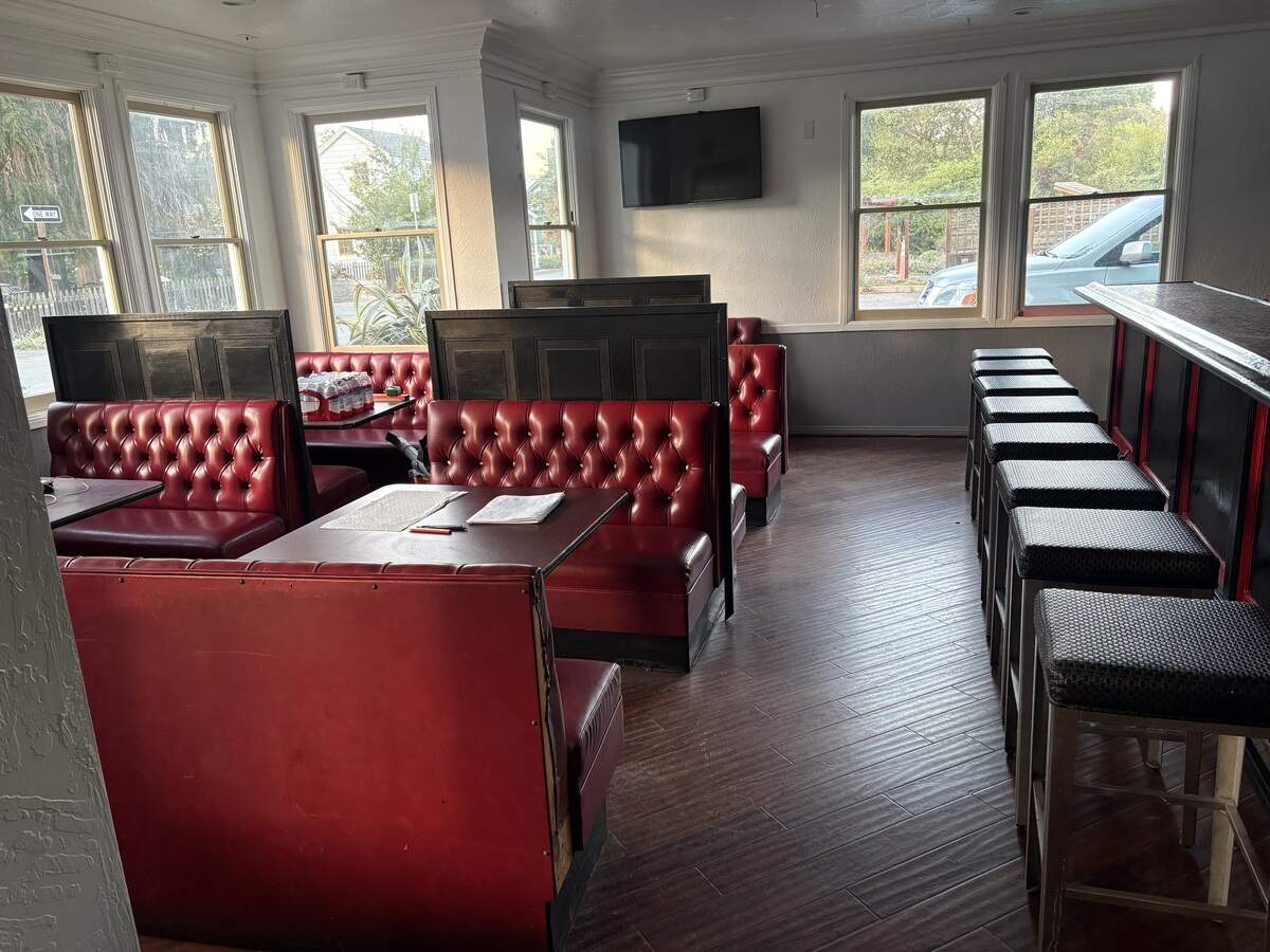 The bright dining room at Cambria New Diner will open in July 2026 with a vibrant red-and-black decor.