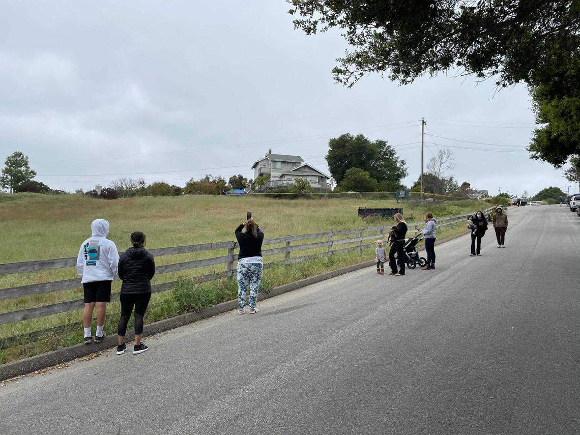 People line up outside the home of Ruben Flores, after news of two arrests being made in the disappearance of Cal Poly student Kristin Smart.
