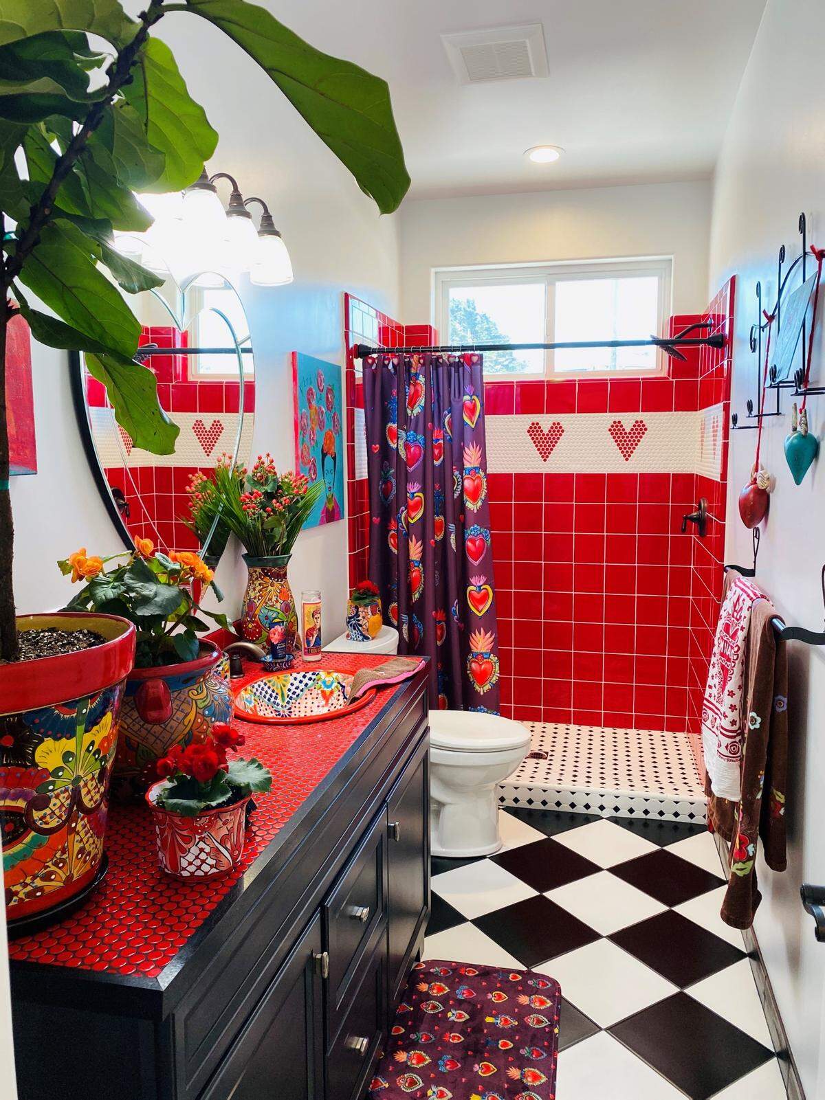 In the guest bathroom of Barb and Jeri Saia’s Los Osos home, traditional tile styles such as hexagon, harlequin and subway take on new life with bold red and turquoise.&nbsp;