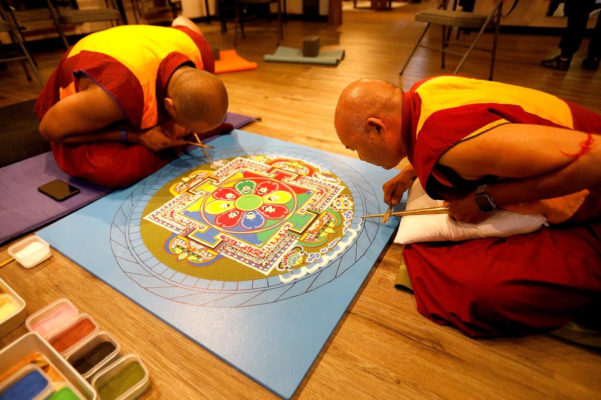 Tibetan monks from India began to build a sand mandala at the Aligned Acupuncture and Wellness Spa in San Luis Obispo on Sept. 24, 2024. They will destroy the mandala on Sept. 27, 2024. Tibetan monks, Lobsang Dhamchoe, left, and Thupten Kunkhen, carefully create the mandala.