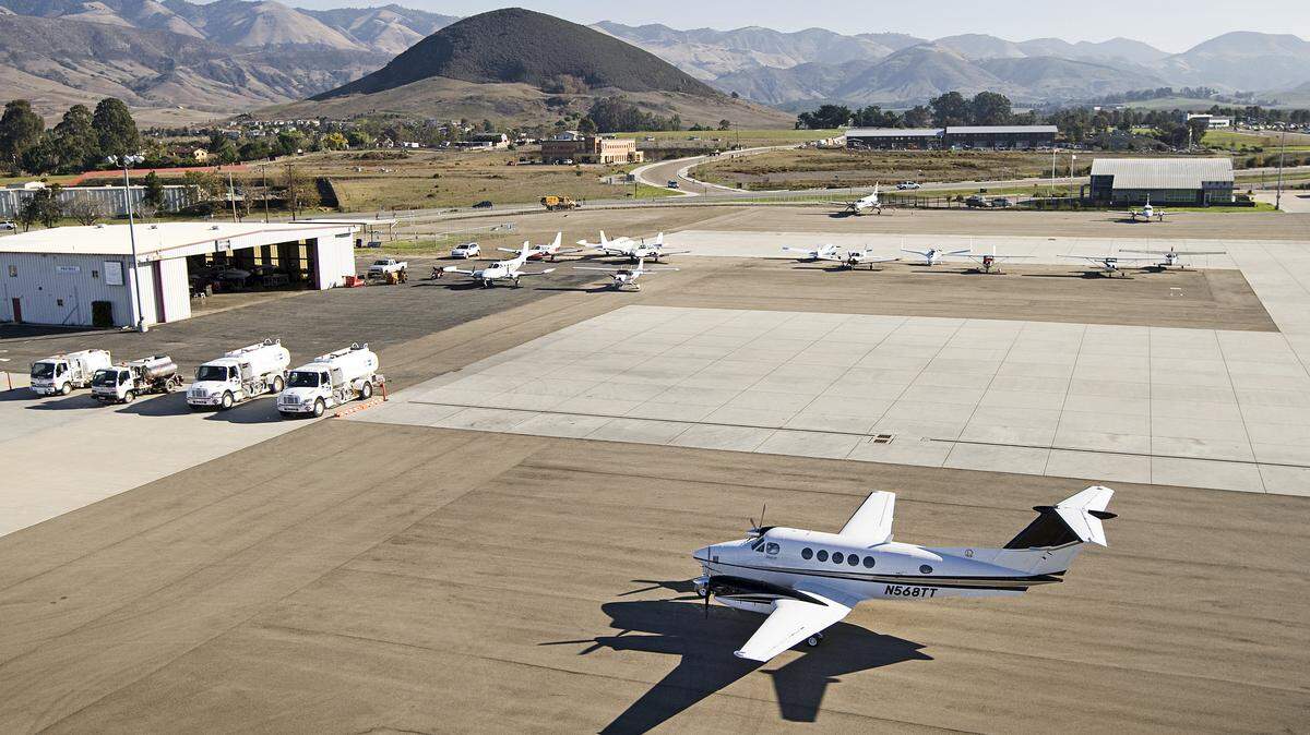 A large portion of the area behind this taxiing airplane, foreground, will be developed into a new terminal at the San Luis Obispo County Regional Airport.