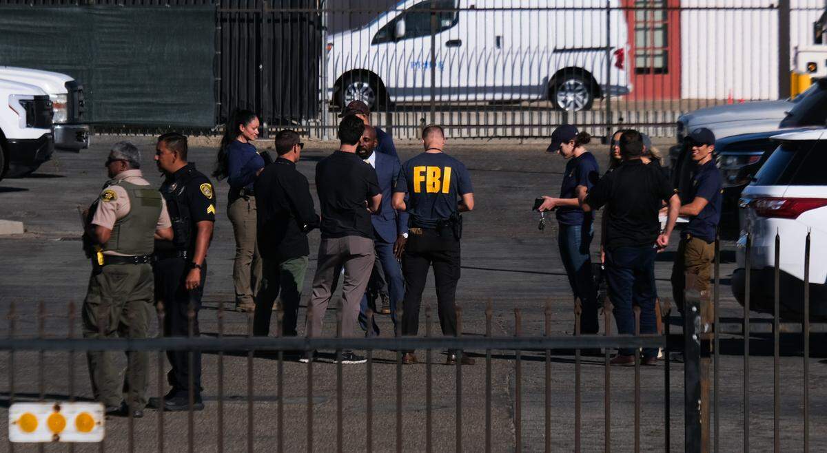 FBI agents, Santa Barbara County sheriff’s deputies and other law enforcement personnel gather outside the Santa Maria Public Library prior to a news briefing on the bombing inside the Santa Maria Superior Courthouse on Sept. 25, 2024.