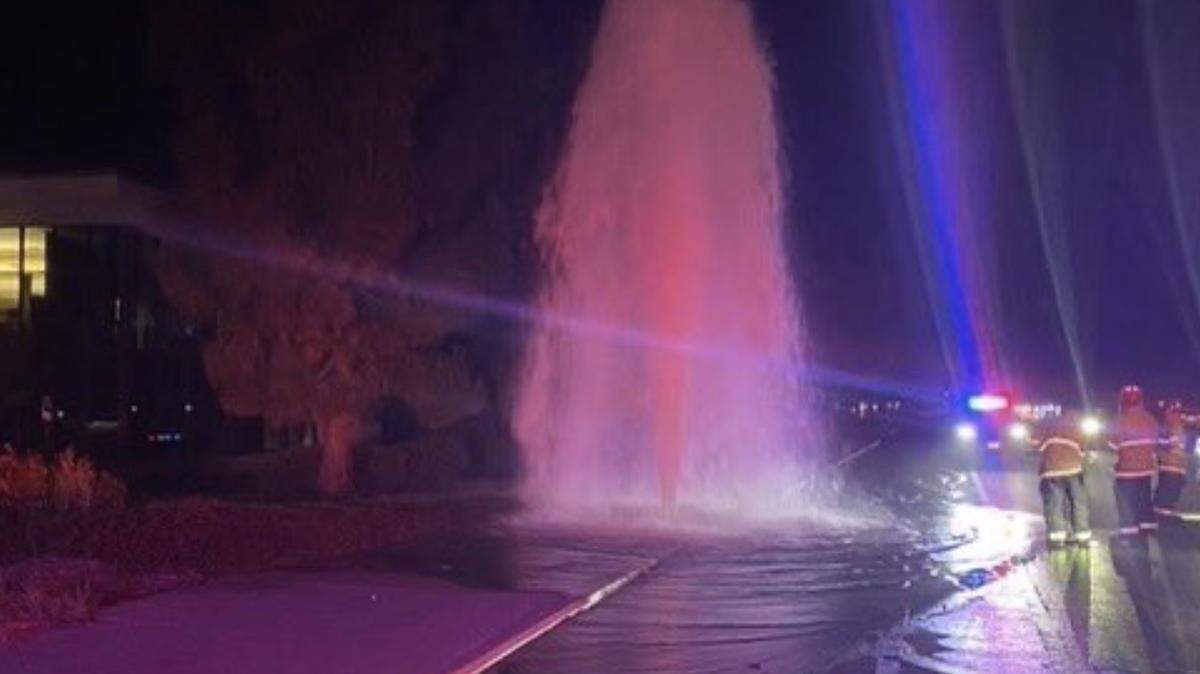 Firefighters observing damage on Broad Street fire hydrant following DUI collision.