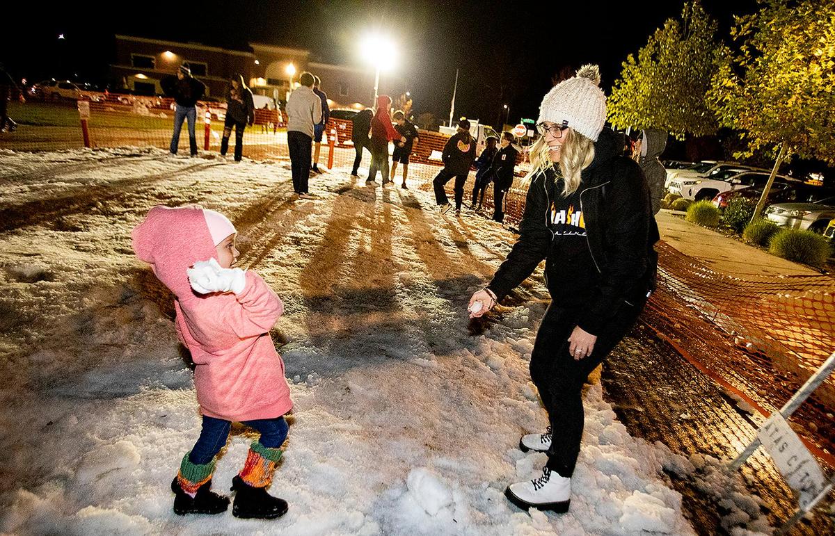 Atascadero resident Willow Scovell, 3, tries to pummel her mom, Kristen Scovell, of Atascadero, with a snowball during Winter Wonderland in 2021. The event returns on Dec. 9, 2022.