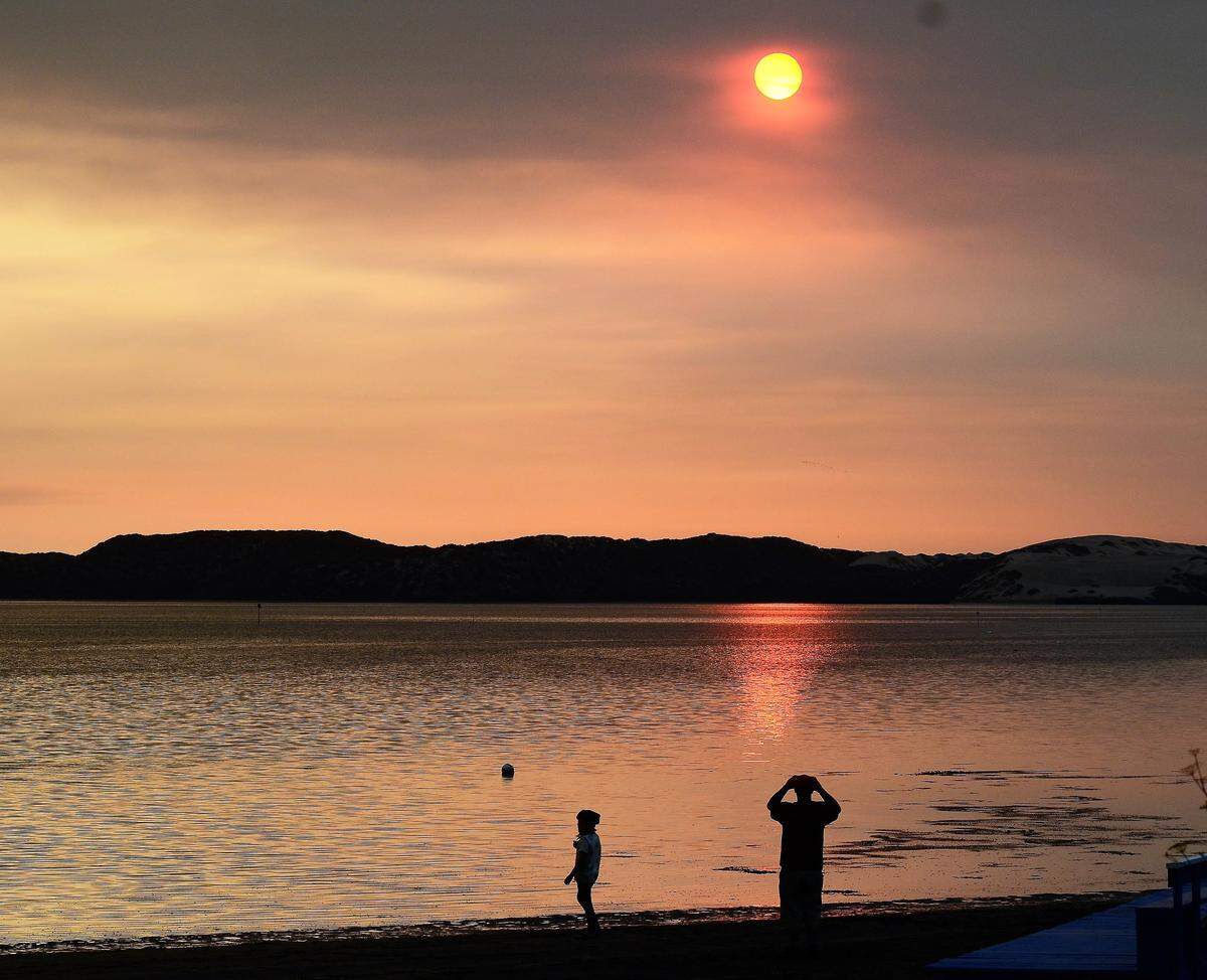 Smoke from the Gifford Fire curls around the sunset in Morro Bay.