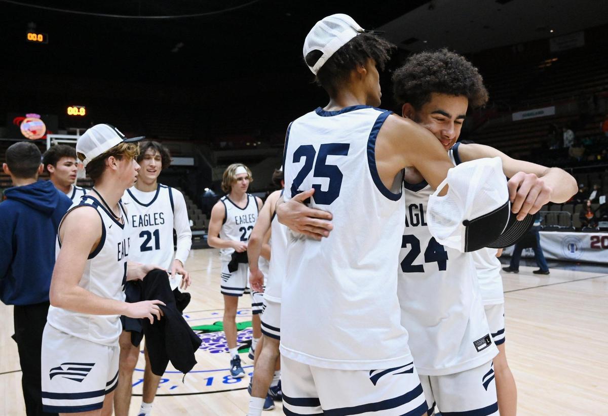 Arroyo Grande’s Adam Silmon, right, embraces Noah Morris after the team’s 59-30 win over Porterville at the CIF Central Section Boys Division 2 basketball championship Friday, Feb. 24, 2023, in Fresno.