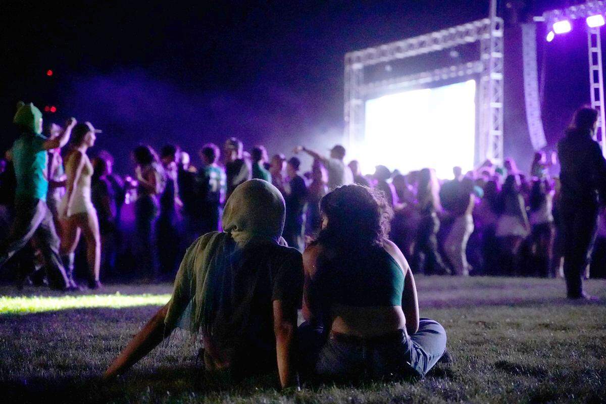 Kaya Endo, a second-year mechanical engineering student, and Xol Vasquez, a second-year educational science student, take a break during the opening set of Morning on the Green on March 14, 2026, at Cal Poly.
