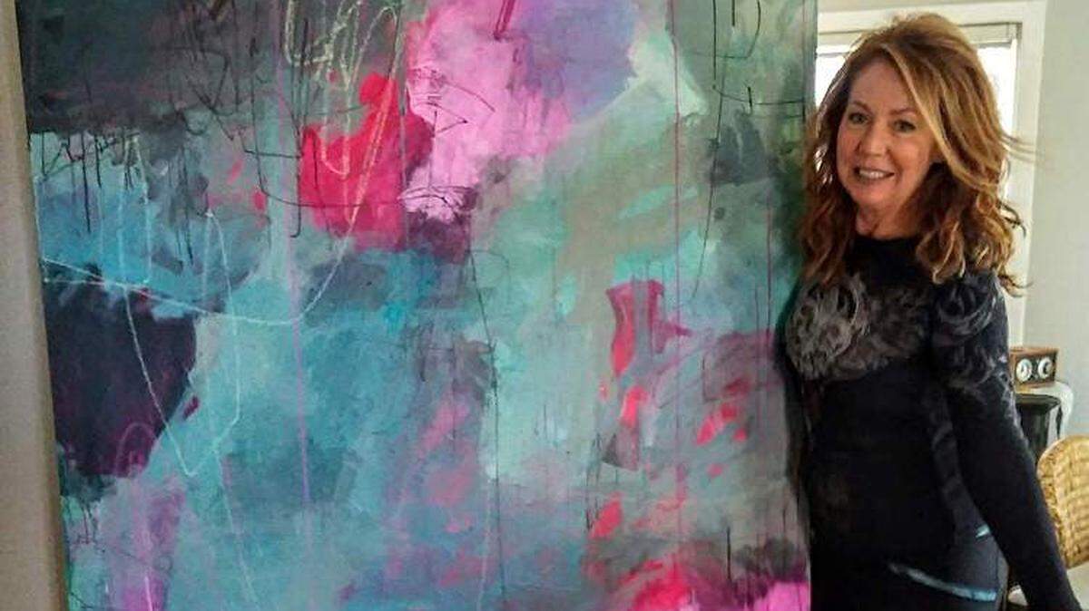 Clovis artist Jeanette Goulart with one of her paintings.