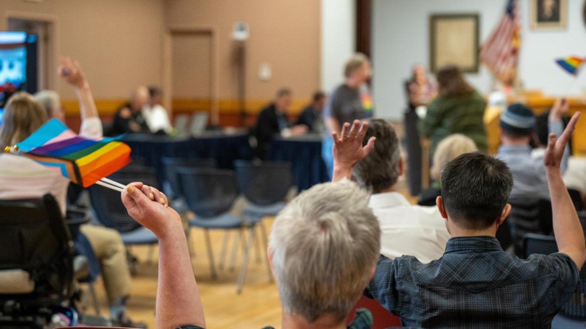 Onlookers wave Pride flags during the Morro Bay City Council meeting on Tuesday, May 14, 2022. Pride flags and other commemorative flags will not be flown over Morro Bay city buildings following 2025’s Pride month after the City Council voted to repeal a 2022 ordinance that allowed for commemorative flags to be flown.