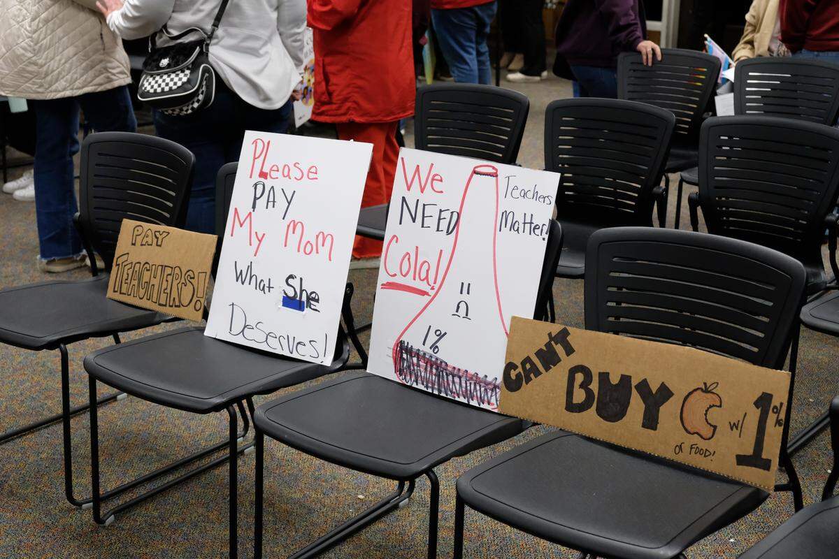After public comment, meeting attendees left signs on their chairs, urging the Paso Robles school board to approve a cost-of-living adjustment higher than the proposed 1% for teachers. January 27, 2026.