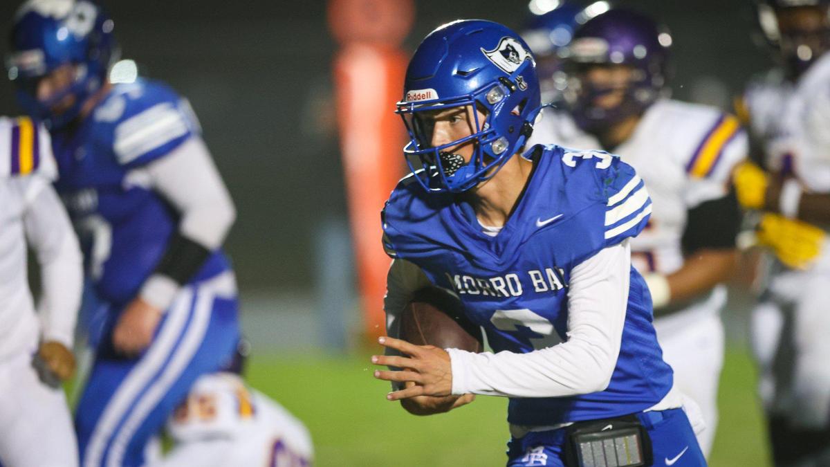 Nicky Johnson runs after finding receivers covered in a game Morro Bay led 28-13 over Fresno before it was canceled due to lightning on Sept. 9, 2022.