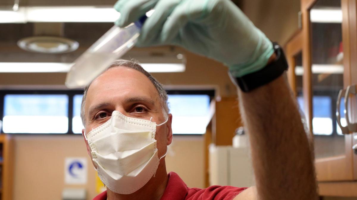 Pat Fidopiastis, Cal Poly microbiology professor holds a sample of sewer water that will be used to track the health of several dorm buildings. It can be an early warning system to track coronavirus.