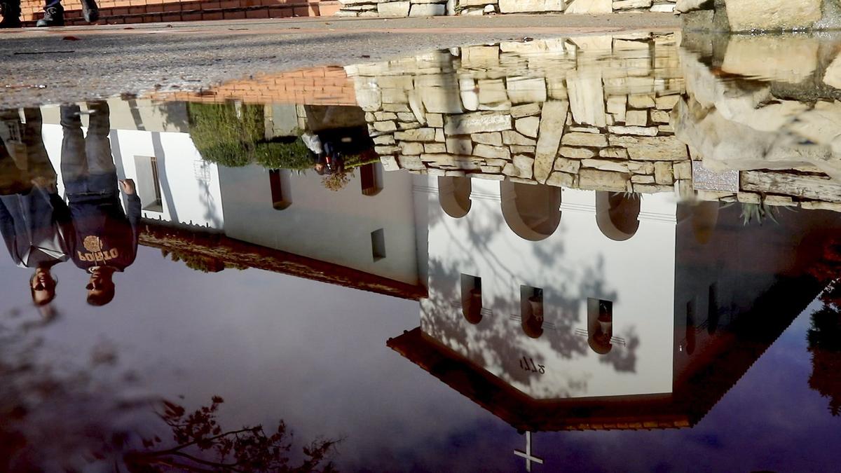 Early December rain brought puddles to Mission Plaza leading to this reflection of Old Mission San Luis Obispo.
