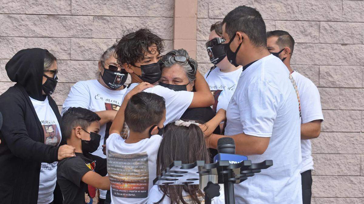 Children and grandchildren embrace Juan Olvera-Preciado’s widow, Silvia, after she spoke about her loss. He was the bystander killed Aug. 21, 2022, in a shooting by Guadalupe police pursuing a suspect.