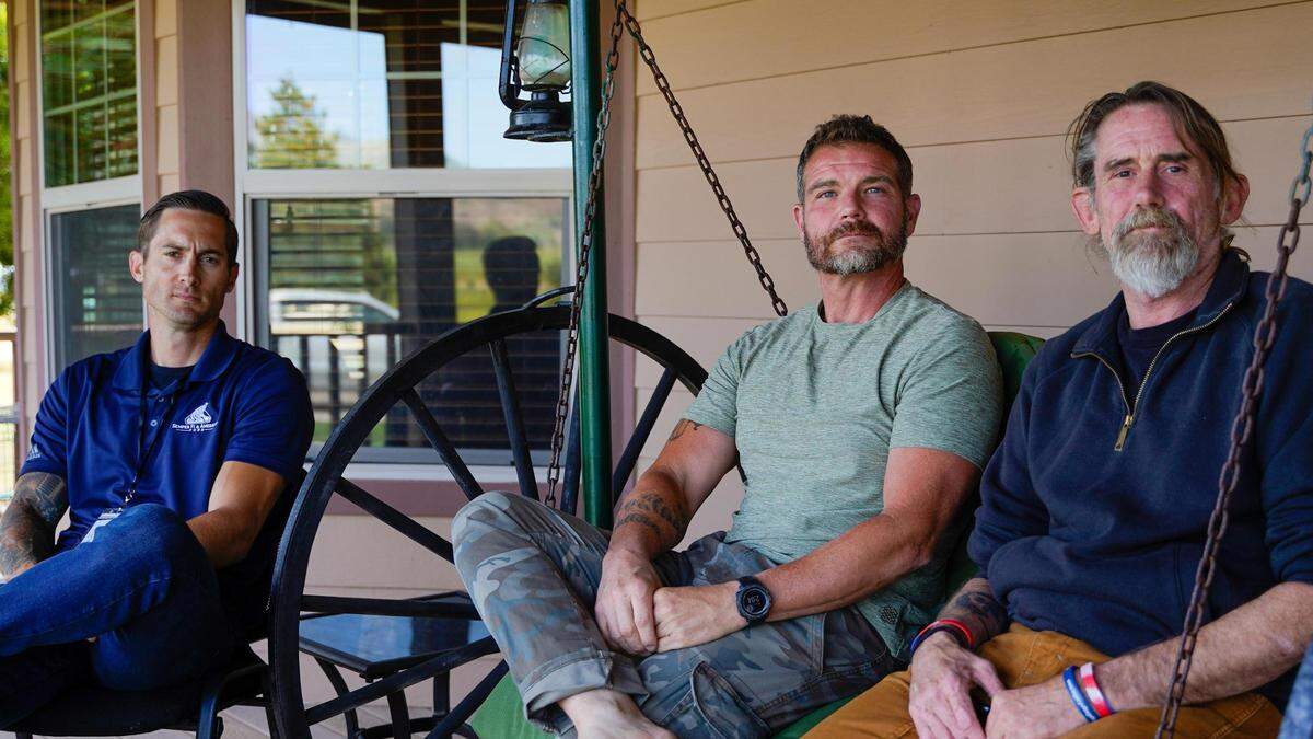 David “Doc” Oliver, left, sits with veterans Joe Franceschi, center, and Brian Clark, right, on the front porch of Nipomo-based Legacy Village Wellness Center. Clark and Franceschi were clients of the facility but were discharged from the organization’s care following what Legacy Village says was an apparent decision by the Greater Los Angeles Veterans Affairs Office to stop referring clients to them.