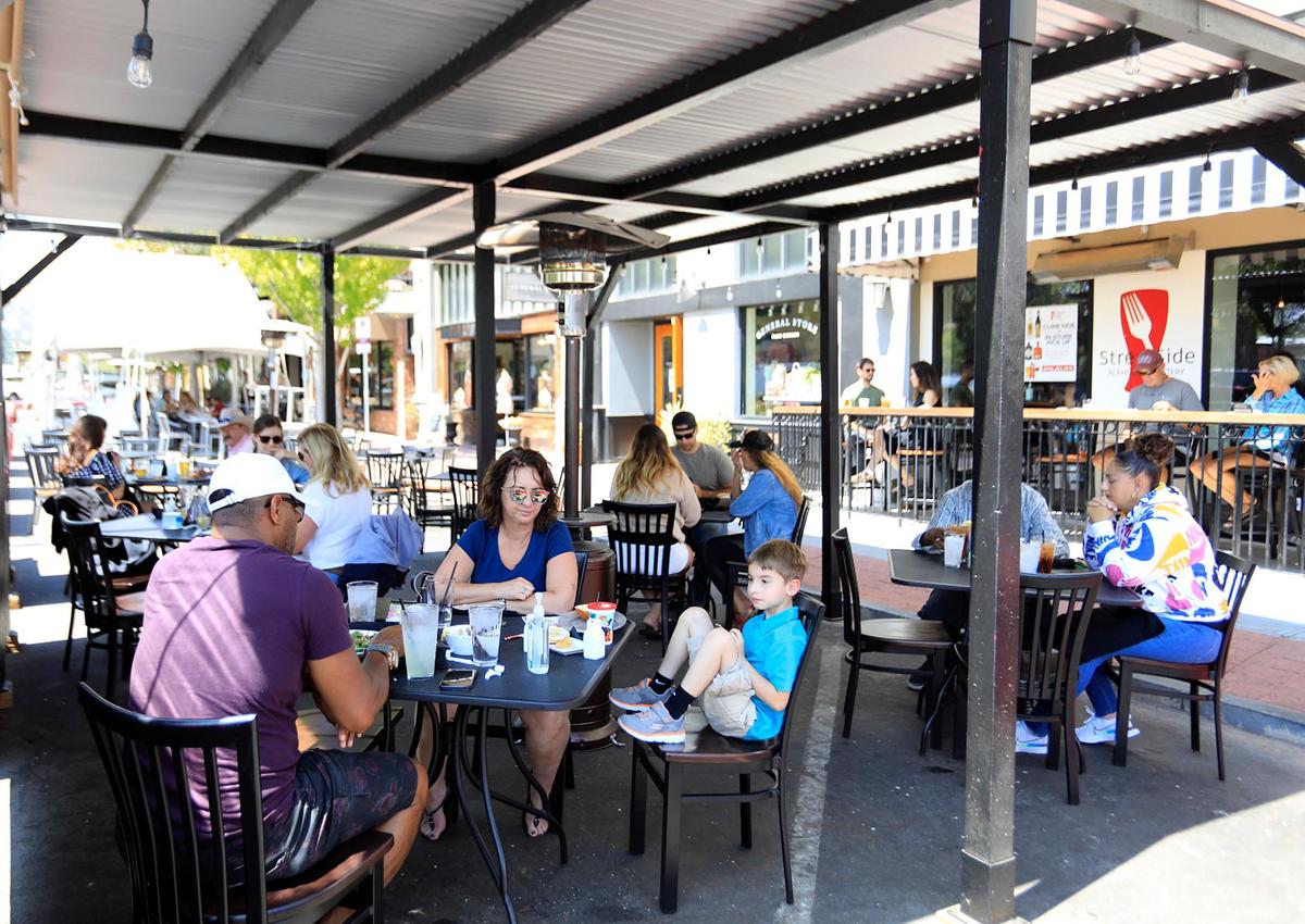 Diners enjoy lunch in a parklet outside Streetside in Paso Robles in October 2021. The city ended its temporary parklet program in November 2021 and is now discussing whether to create a permanent program of some kind.