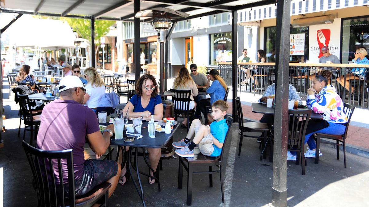 Diners enjoy lunch in a parklet outside Streetside in Paso Robles. The City Council is weighing whether to end its downtown parklet program, created to help restaurants during COVID-19.