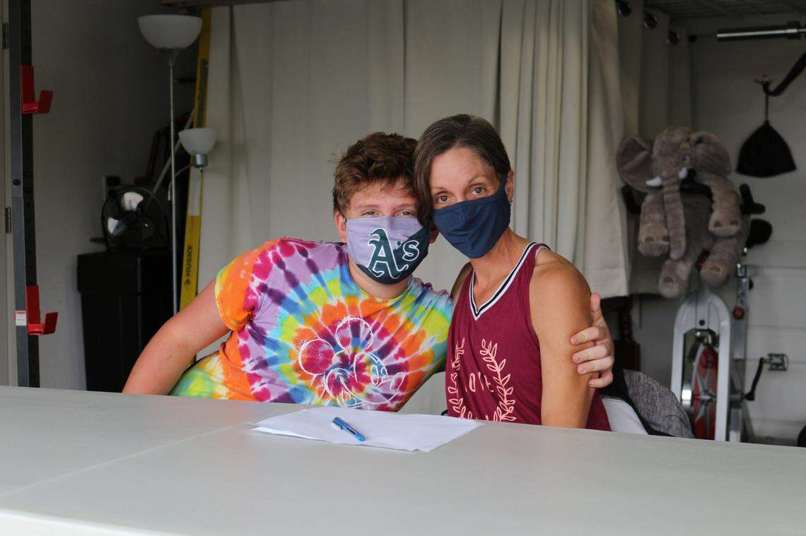 Hunter Wooldridge hugs his mom, Serema, in their home in Arroyo Grande on Oct. 25, 2020. Hunter struggled to keep his grades up last year, despite being a straight-A student in previous years.